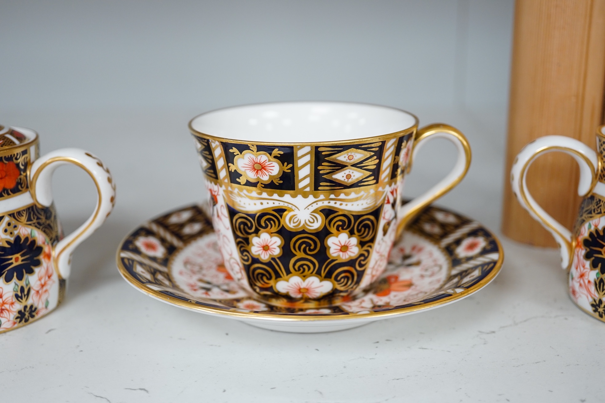 Two Royal Crown Derby sugar bowls, and a cup and saucer, largest 9cm high. Condition - good.